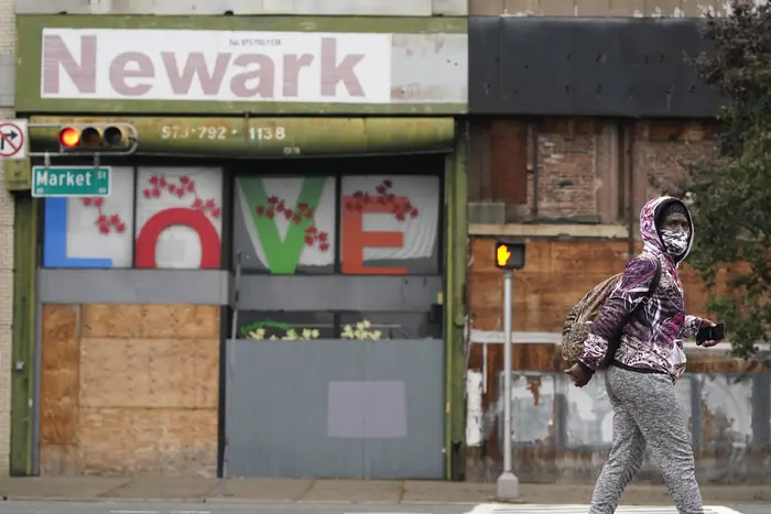Pedestrian wears a mask as they walk through Newark, New Jersey.